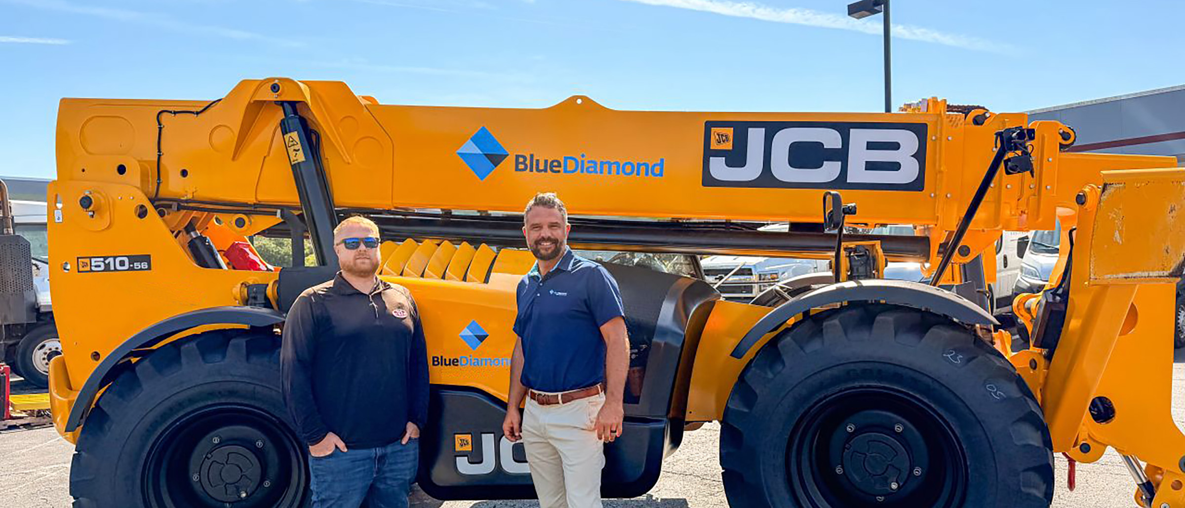Riley Yeaman and Mike Grimes with a BlueDiamond JCB telehandler at the equipment yard